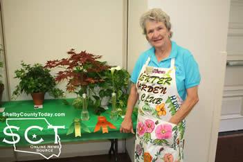 Judy Matthews was presented with an Arboreal Award and an Award of Merit for her Japanese Maple Tree and Calla Lily .