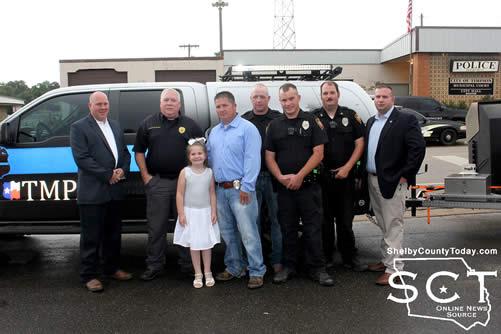 Timpson Police Officers and TMPA representatives are seen together outside Timpson City Hall.